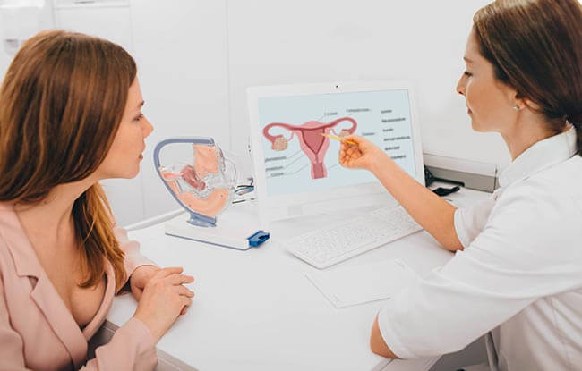 Image of a woman receiving cervical smear test advice 